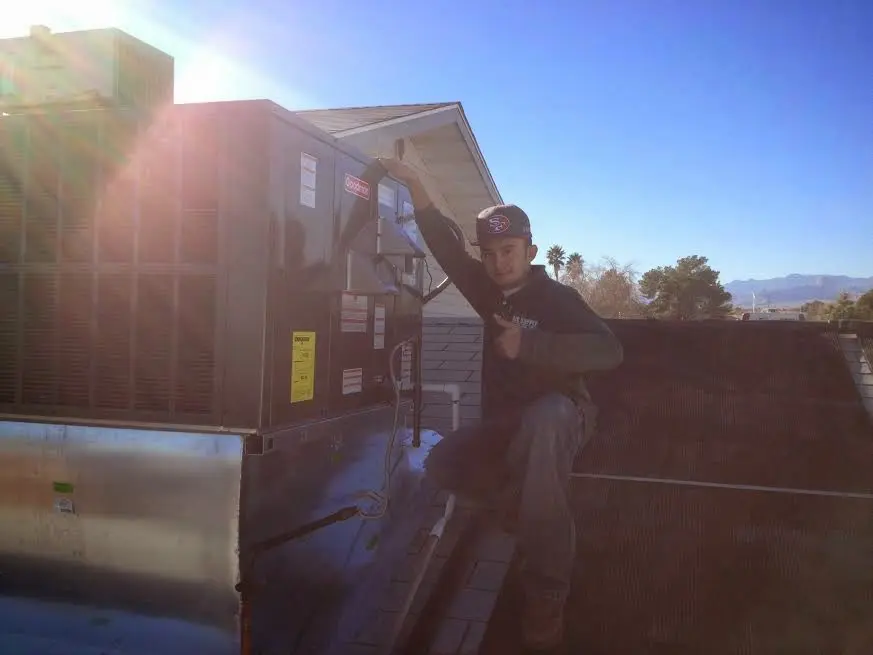 HVAC technician performing HVAC Inspection on a rooftop unit in Mayflower Village